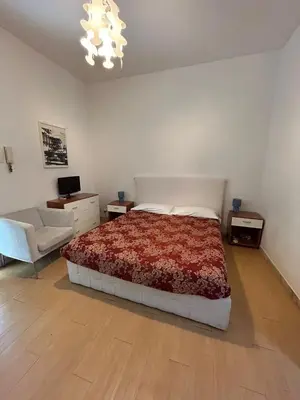 a bedroom with a bed and a couch and a chair at Great studio near Coliseum in Rome