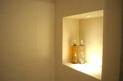 two bottles ofodorizers sit on a shelf in a bathroom at Le Dimore del Duca in Rome