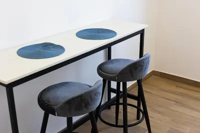 two stools at a counter with two blue plates at Vatican Walls Apartment in Rome