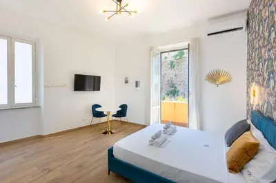 a bedroom with a bed and a desk in a room at Vatican Walls Apartment in Rome