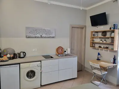 a kitchen with a washer and dryer in it at Monolocale luminoso vicino Trastevere in Rome