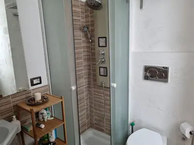 a bathroom with a shower and a toilet and a sink at Monolocale luminoso vicino Trastevere in Rome