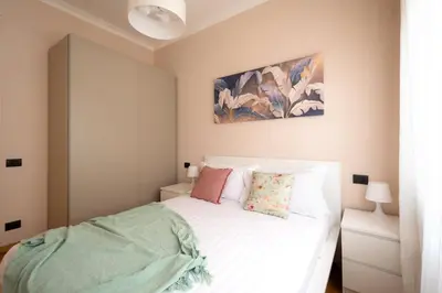 a bedroom with a white bed with towels on it at Modern Apartment near Vatican & Foro Italico - Rome in Rome