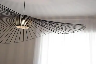 a fan hanging from a ceiling next to a window at App Leoncino Design Apartment in Rome in Rome