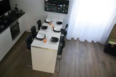 a white table with black chairs and a table with glasses at App Leoncino Design Apartment in Rome in Rome