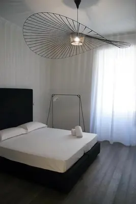 a bedroom with a large bed with a light at App Leoncino Design Apartment in Rome in Rome
