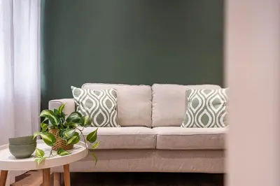 a living room with a couch with pillows and a table at Casa Bressan in Rome