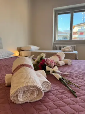 a bed with flowers and towels on top of it at Giorgi House in Rome