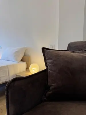 a living room with a couch and a bed at Giorgi House in Rome