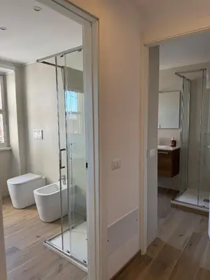 a bathroom with a glass shower and a toilet at Giorgi House in Rome