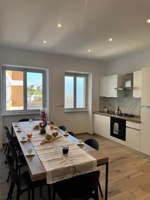 a kitchen and dining room with a table and chairs at Giorgi House in Rome