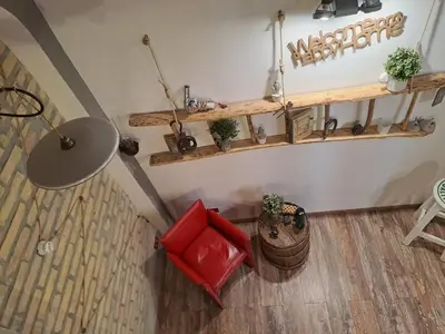 an overhead view of a living room with a red chair and shelves at FCR Rome Apartments Sweet Nest of Love in Rome