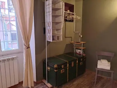 a room with a green trunk in a room with a window at FCR Rome Apartments Sweet Nest of Love in Rome