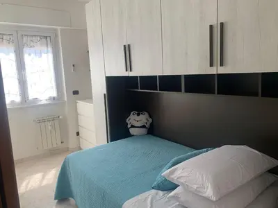 a bedroom with a bed and white cabinets at Lilly's Apartment a 5 minuti Metro C in Rome