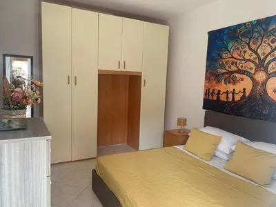a bedroom with a bed and a painting on the wall at Lilly's Apartment a 5 minuti Metro C in Rome