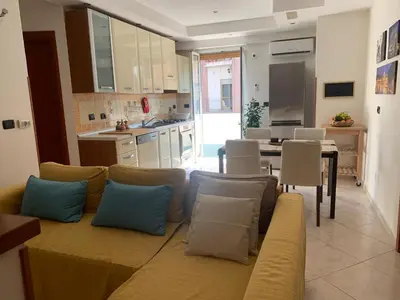 a living room with a couch and a kitchen at Lilly's Apartment a 5 minuti Metro C in Rome