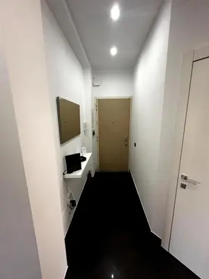 a hallway with a bathroom with a sink and a mirror at Dimora Battistini in Rome