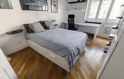 a small bedroom with a bed and a desk at Large Room with private Bathroom in Rome