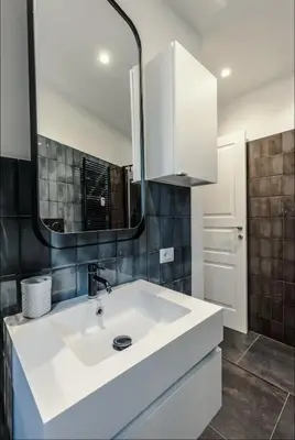 a bathroom with a white sink and a mirror at Large Room with private Bathroom in Rome