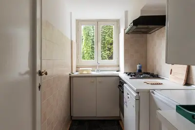 a small kitchen with a sink and a window at GuestHost - Historic Center Apartment Lungotevere in Rome