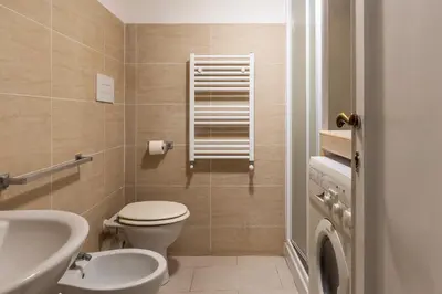 a bathroom with a toilet and a sink at GuestHost - Historic Center Apartment Lungotevere in Rome