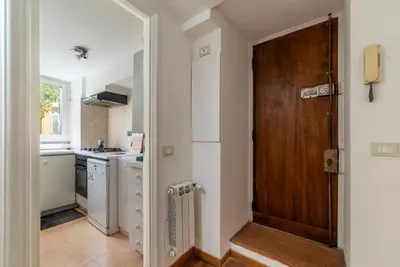 a kitchen with a wooden door in a room at GuestHost - Historic Center Apartment Lungotevere in Rome