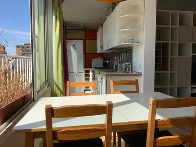 a kitchen with a table and chairs on a balcony at camera singola al Pigneto in Rome
