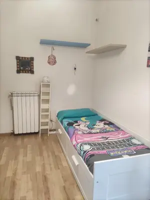 a bed with a quilt on it in a room at camera singola al Pigneto in Rome