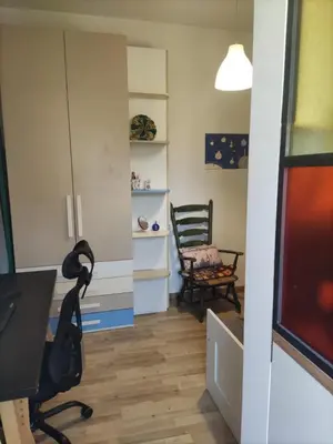 a living room with a desk and a chair at camera singola al Pigneto in Rome