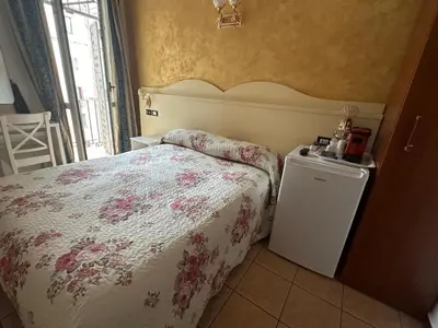 a bedroom with a bed with a floral bedspread at Near Termini station in Rome