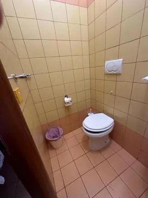 a bathroom with a white toilet in a stall at Near Termini station in Rome