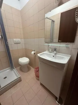 a bathroom with a sink and a toilet and a mirror at Near Termini station in Rome