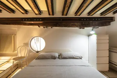 a bedroom with a bed and a table and a window at Navona award Collection in Rome
