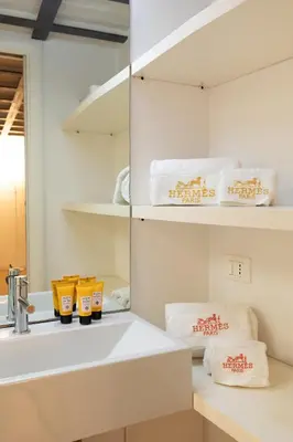 a bathroom with a sink and a mirror and towels at Navona award Collection in Rome