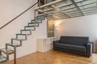 a living room with a staircase and a couch at Navona award Collection in Rome