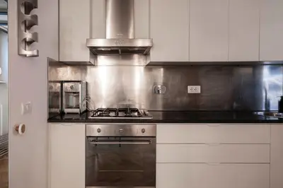 a kitchen with a stove and a microwave at Navona award Collection in Rome