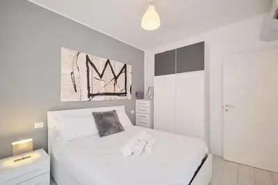 a bedroom with a white bed with two white towels at Apt at Tiburtina Station Free WiFi e Netflix in Rome