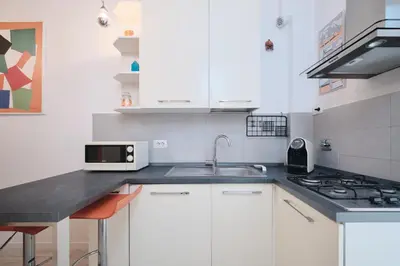 a kitchen with white cabinets and a sink at Apt at Tiburtina Station Free WiFi e Netflix in Rome