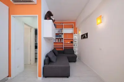 a dog sitting on top of a staircase in a room at Apt at Tiburtina Station Free WiFi e Netflix in Rome