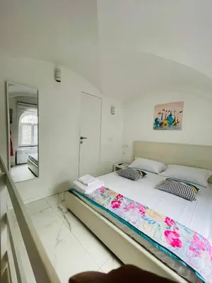 a bedroom with a bed and a mirror at Loft Flower Colosseum in Rome