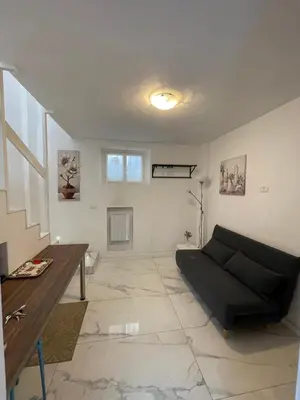 a living room with a couch and a table at Loft Flower Colosseum in Rome