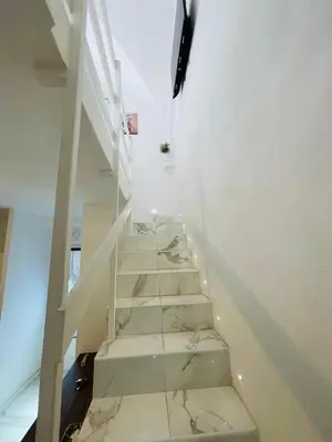 a staircase in a house with marble floors and white walls at Loft Flower Colosseum in Rome