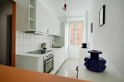 a white kitchen with a sink and a stove at Casa Chiro 79 in Rome