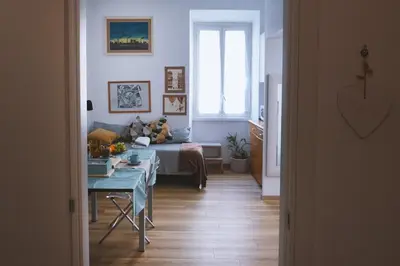 a bedroom with a bed and a table in a room at Charming 3-Guest Apt in San Giovanni Landmark in Rome
