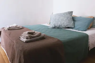 a bedroom with two beds with towels on them at Charming 3-Guest Apt in San Giovanni Landmark in Rome