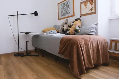 a bedroom with a bed and a floor lamp at Charming 3-Guest Apt in San Giovanni Landmark in Rome