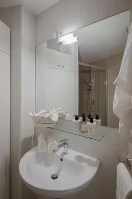 a bathroom with a sink and a mirror at Tiber Island View - Trastevere, Campo de' Fiori in Rome