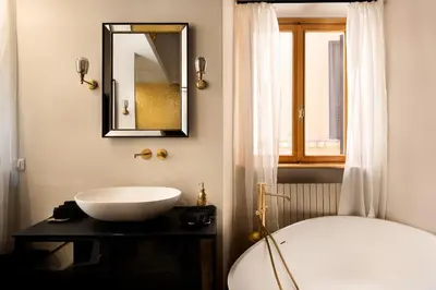 a bathroom with a white sink and a mirror at Idyllia - Luxury home with terrace in Rome