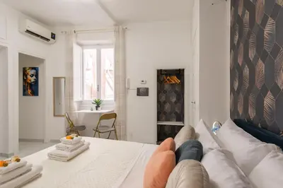 a person laying on a couch in a living room at Appartamento vicolo Savelli in Rome