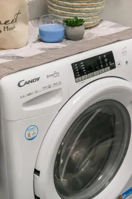 a white washing machine sitting on top of a counter at Appartamento vicolo Savelli in Rome